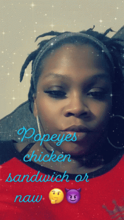 A Woman Wearing A Red Shirt With Popeye 'S Chicken Sandwich Or Naw Written On It GIF