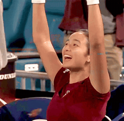 A Woman Wearing A Red Shirt With The Letter F On It GIF