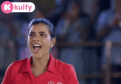 A Woman Wearing A Red Shirt With The Number 03 On It Is Smiling GIF