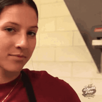 A Woman Wearing A Red Shirt With The Words Double Fries On The Bottom GIF