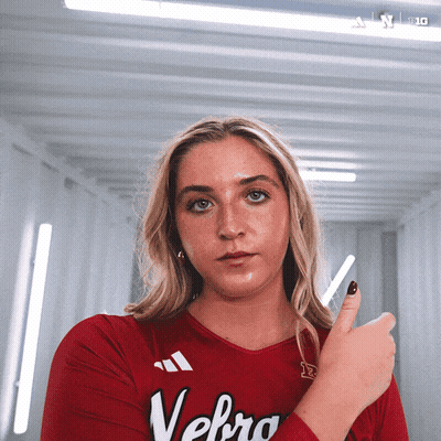 A Woman Wearing A Red Shirt With Velbro On It GIF