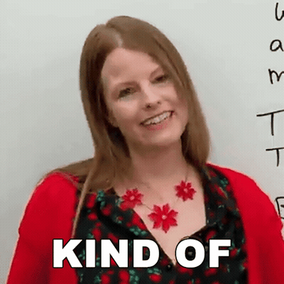 A Woman Wearing A Red Sweater And A Necklace With Red Flowers Is Smiling And The Words Kind Of Are Above Her GIF