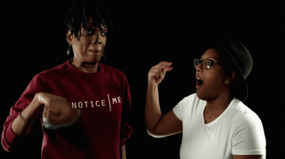 A Woman Wearing A Red Sweater That Says Notice Me On It GIF