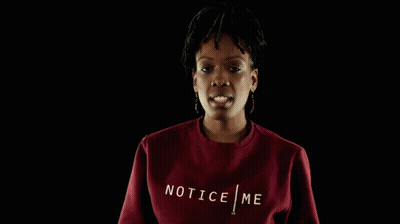 A Woman Wearing A Red Sweatshirt With The Word Tic On The Front GIF