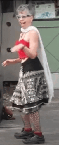 Woman In Red Top And Gray Skirt On Street GIF