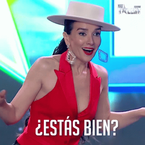 A Woman Wearing A Red Top And A White Hat Is Asking If She Is Ok GIF