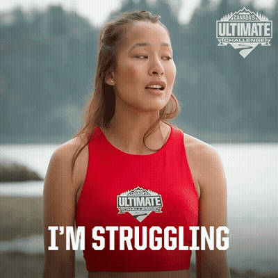A Woman Wearing A Red Ultimate Challenge Tank Top GIF