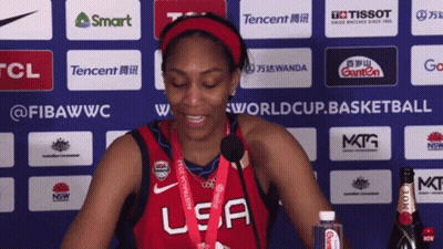 A Woman Wearing A Red Usa Jersey Is Smiling GIF