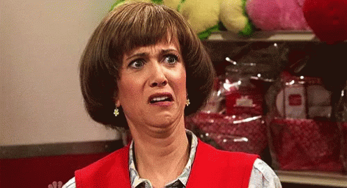 A Woman Wearing A Red Vest Is Making A Funny Face GIF
