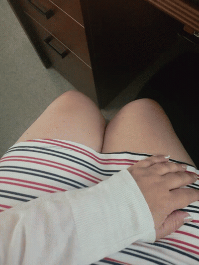 A Woman Wearing A Red White And Blue Striped Skirt Holds Her Hands To Her Chest GIF