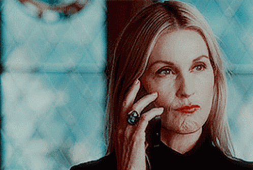 A Woman Wearing A Ring Talks On A Cell Phone GIF