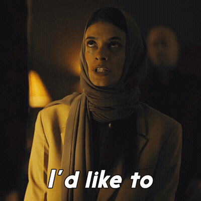 A Woman Wearing A Scarf And A Jacket Says " See You Try " GIF