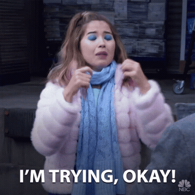 A Woman Wearing A Scarf And A Pink Coat Says I 'M Trying Okay GIF