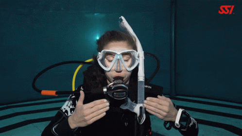 A Woman Wearing A Scuba Gear With The Letters Ssi On The Bottom Right GIF