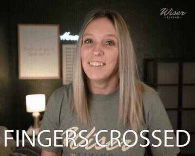 A Woman Wearing A Shirt That Says Fingers Crossed On It GIF