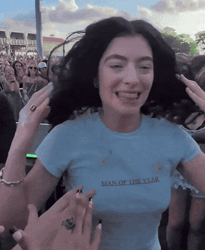 A Woman Wearing A Shirt That Says Man Of The Year On It GIF