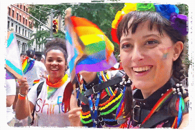A Woman Wearing A Shirt That Says " Shine " Smiles While Holding A Rainbow Flag GIF
