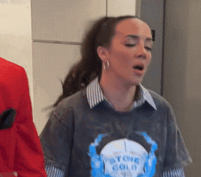 A Woman Wearing A Shirt That Says " Stone Cold " GIF