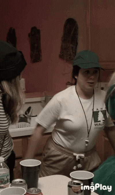 A Woman Wearing A Shirt That Says Wald Is Standing In A Kitchen GIF