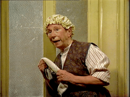 A Woman Wearing A Shower Cap Holds A Towel In Her Hands GIF