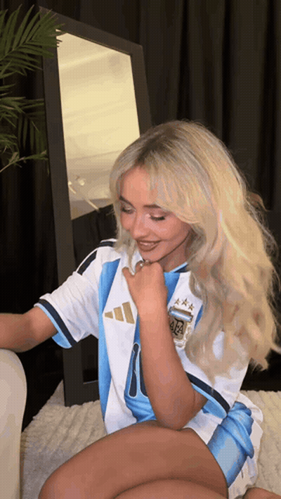 A Woman Wearing A Soccer Jersey With The Letters Aa On It GIF