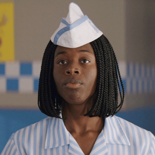 A Woman Wearing A Striped Shirt And A White Hat With The Word Wendy 'S On It GIF