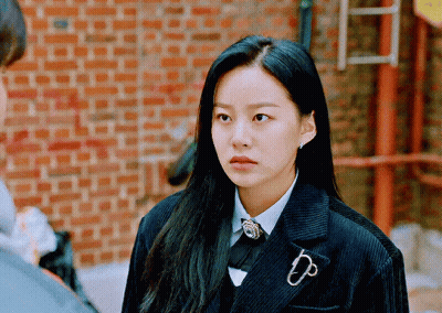 A Woman Wearing A Suit With A Brooch That Says Dp On It GIF