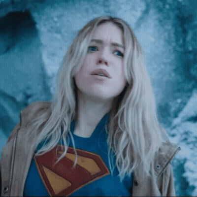 A Woman Wearing A Superman T-Shirt And A Jacket GIF