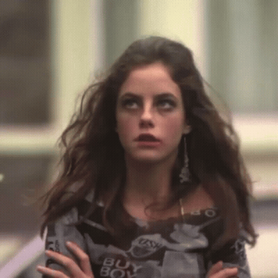 A Woman Wearing A Sweater That Says Buy Boy On It GIF