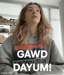 A Woman Wearing A Sweater That Says Gawd Dayum GIF