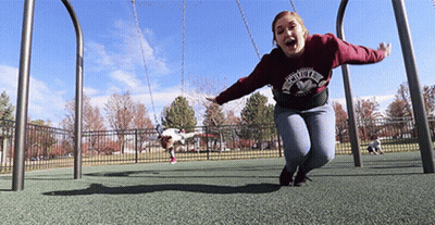 A Woman Wearing A Sweatshirt That Says ' Faith ' On It Is Swinging On A Swing Set GIF