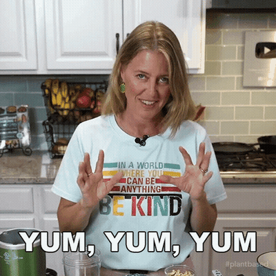 A Woman Wearing A T-Shirt That Says Be Kind Yum Yum Yum GIF