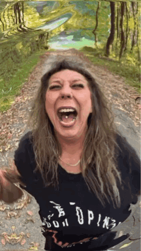 A Woman Wearing A T-Shirt That Says " Do It " Is Laughing With Her Mouth Open GIF