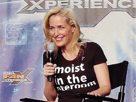 A Woman Wearing A T-Shirt That Says Moist In The Interroom GIF