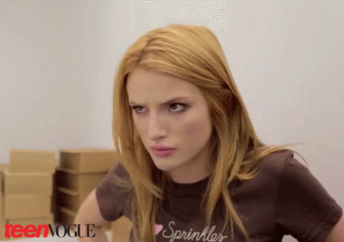 A Woman Wearing A T-Shirt That Says Sprinkles Looks At The Camera GIF