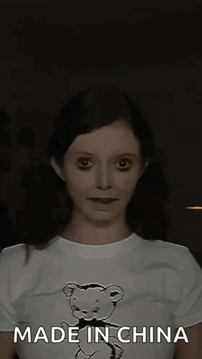A Woman Wearing A T-Shirt With A Teddy Bear On It Is Making A Funny Face . GIF