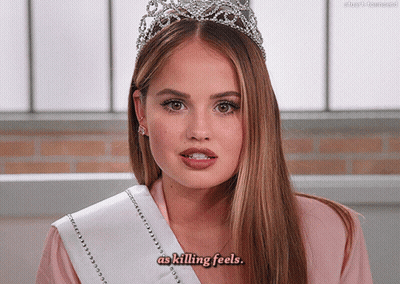 A Woman Wearing A Tiara And A Sash That Says As Killing Feels GIF
