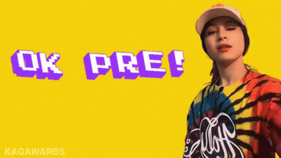 A Woman Wearing A Tie Dye Shirt And A Baseball Cap Says Ok Pre GIF