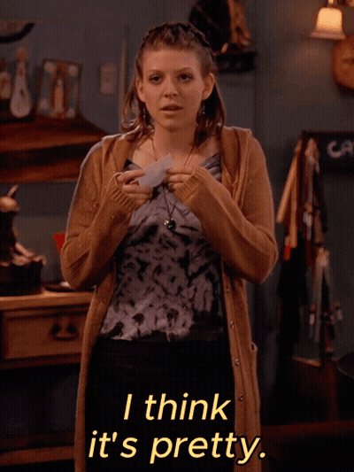 A Woman Wearing A Tie Dye Top And A Tan Cardigan Says I Think It 'S Pretty GIF