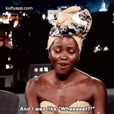 A Woman Wearing A Turban Is Sitting On A Couch And Talking . GIF