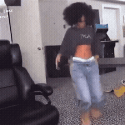 A Woman Wearing A Tyla Crop Top Is Dancing GIF