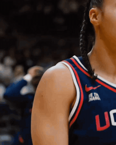A Woman Wearing A Uc Jersey Stands On A Court GIF