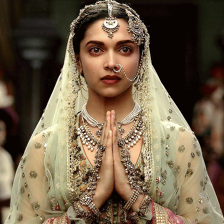 A Woman Wearing A Veil And A Nose Ring Is Praying GIF