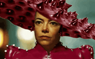 A Woman Wearing A Very Large Red Hat GIF