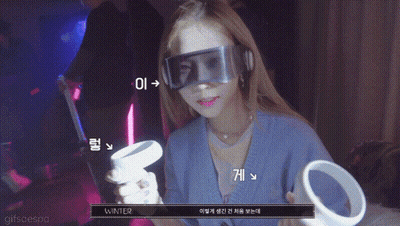 A Woman Wearing A Virtual Reality Headset Is Holding A Controller With The Word Winter Written On It GIF