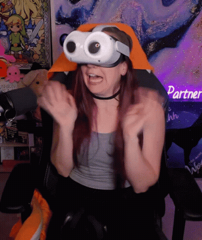 A Woman Wearing A Virtual Reality Headset Sitting In A Chair GIF