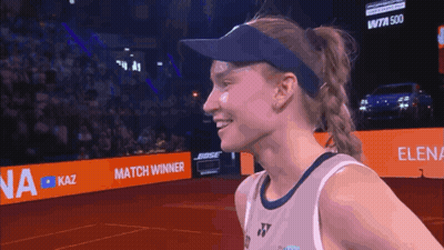 A Woman Wearing A Visor Stands In Front Of A Bose Ad GIF