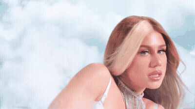 A Woman Wearing A White Bra And A Choker Looks At The Camera GIF