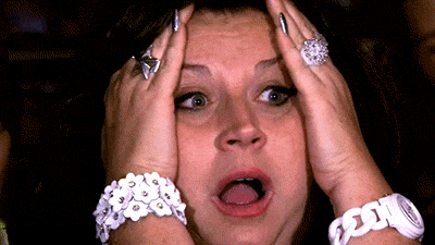 A Woman Wearing A White Bracelet And Rings Holds Her Head In Her Hands GIF