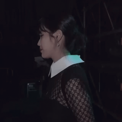 A Woman Wearing A White Collared Shirt Covering Her Mouth With Her Hands GIF